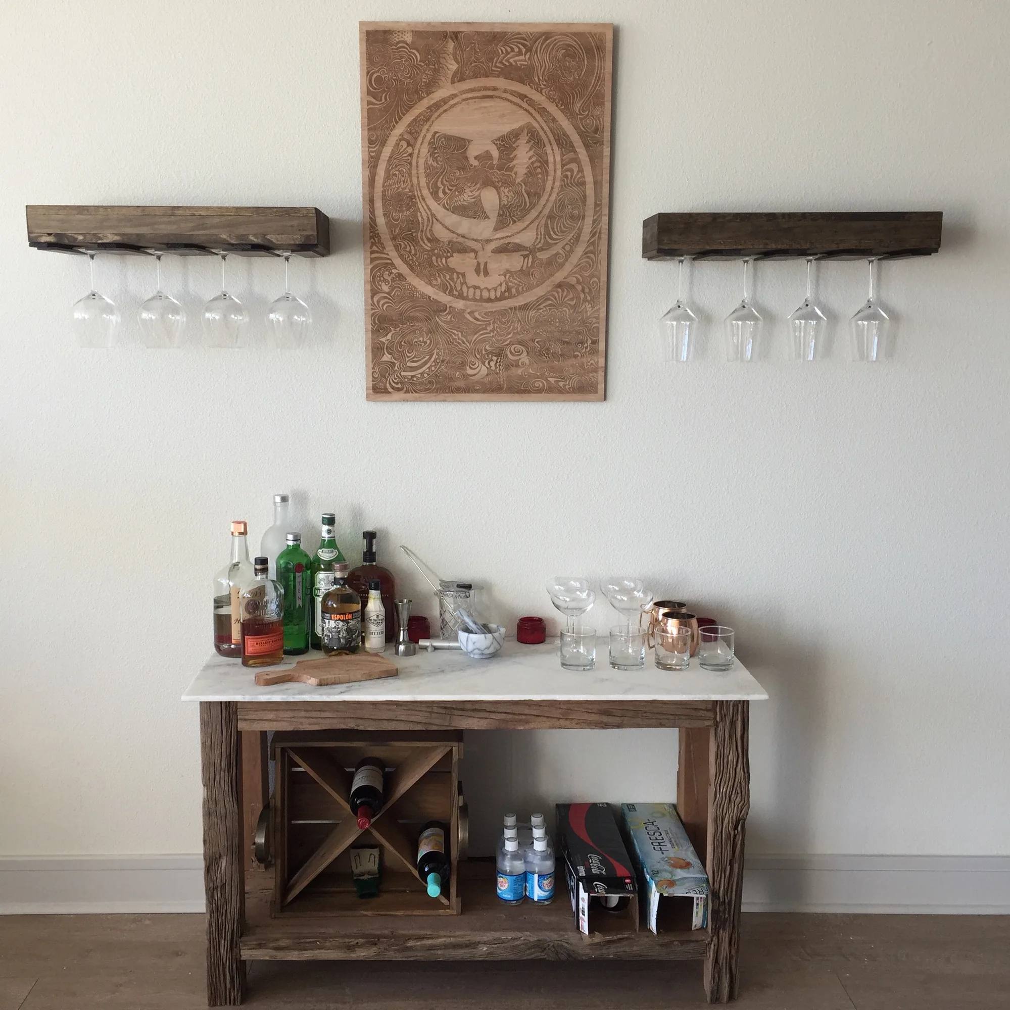 Grateful Tang laser carved panel by Gage Kelsey above a bar cart